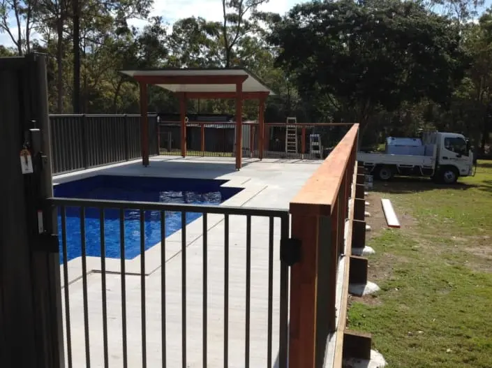 Timber pool surround with handrails and compliant fencing