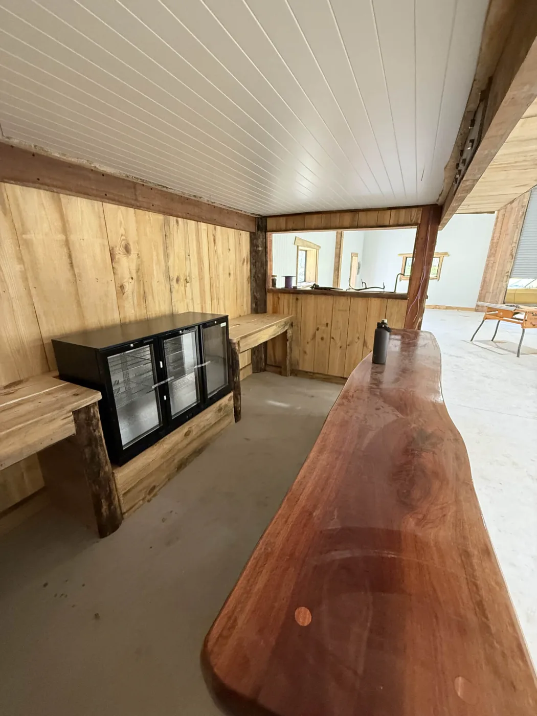 Polished hardwood slab bar top with bar fridges in a Bayside Brisbane man cave