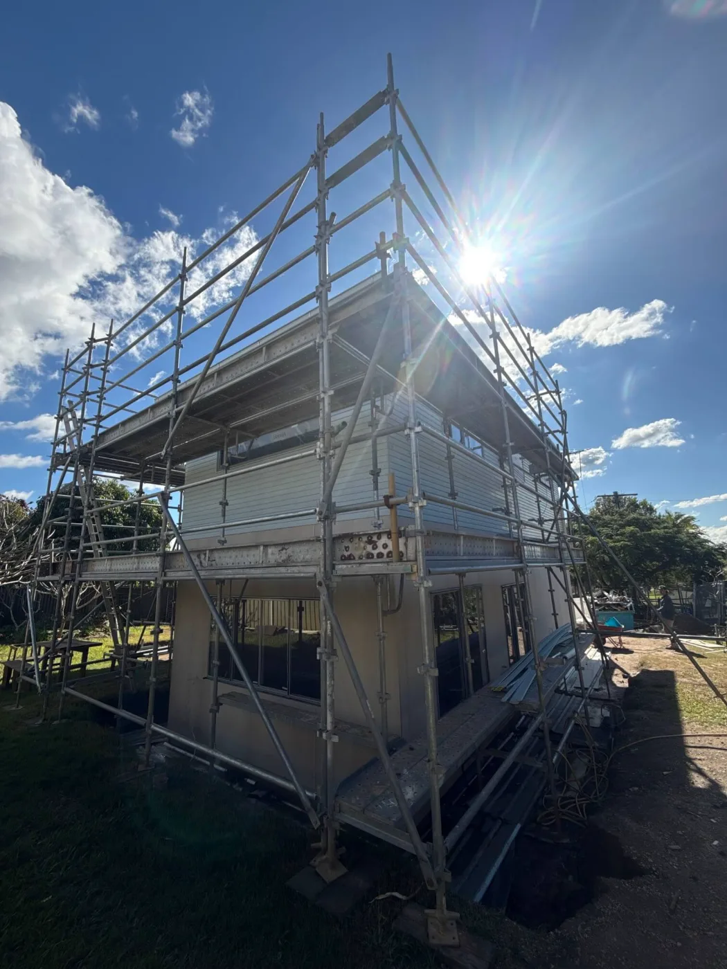 Second-storey extension framed and clad behind scaffolding, Brisbane home renovation