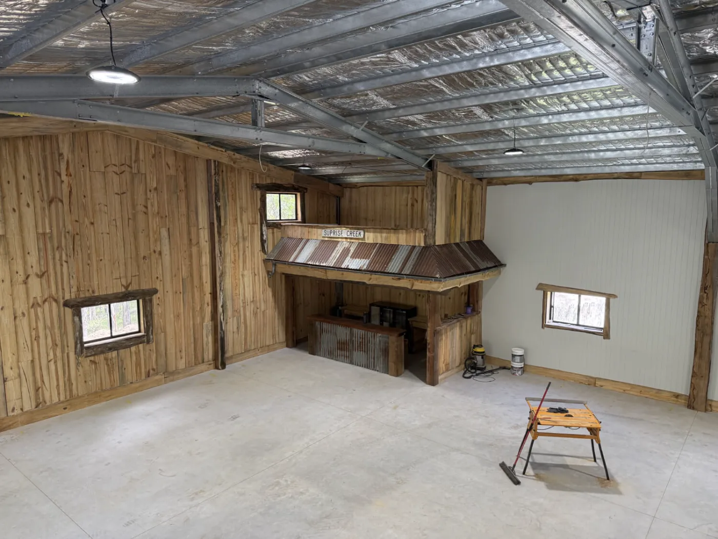 Man cave interior with timber-lined walls and a custom bar built in Bayside Brisbane