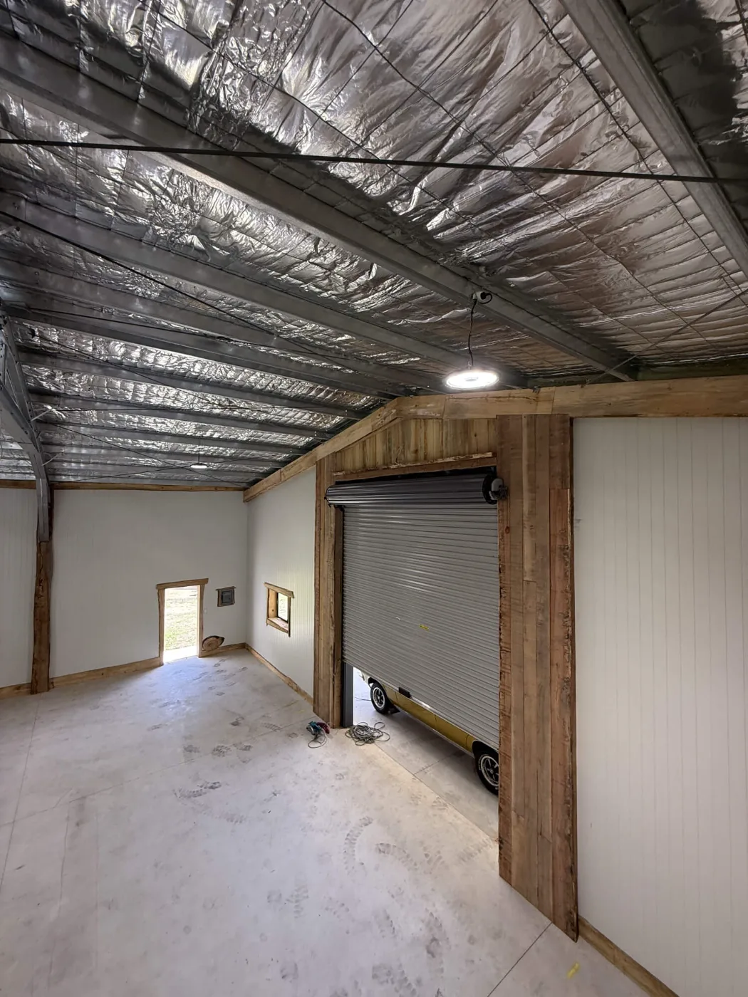 Recycled timber framing around a roller door in a man cave shed fit-out