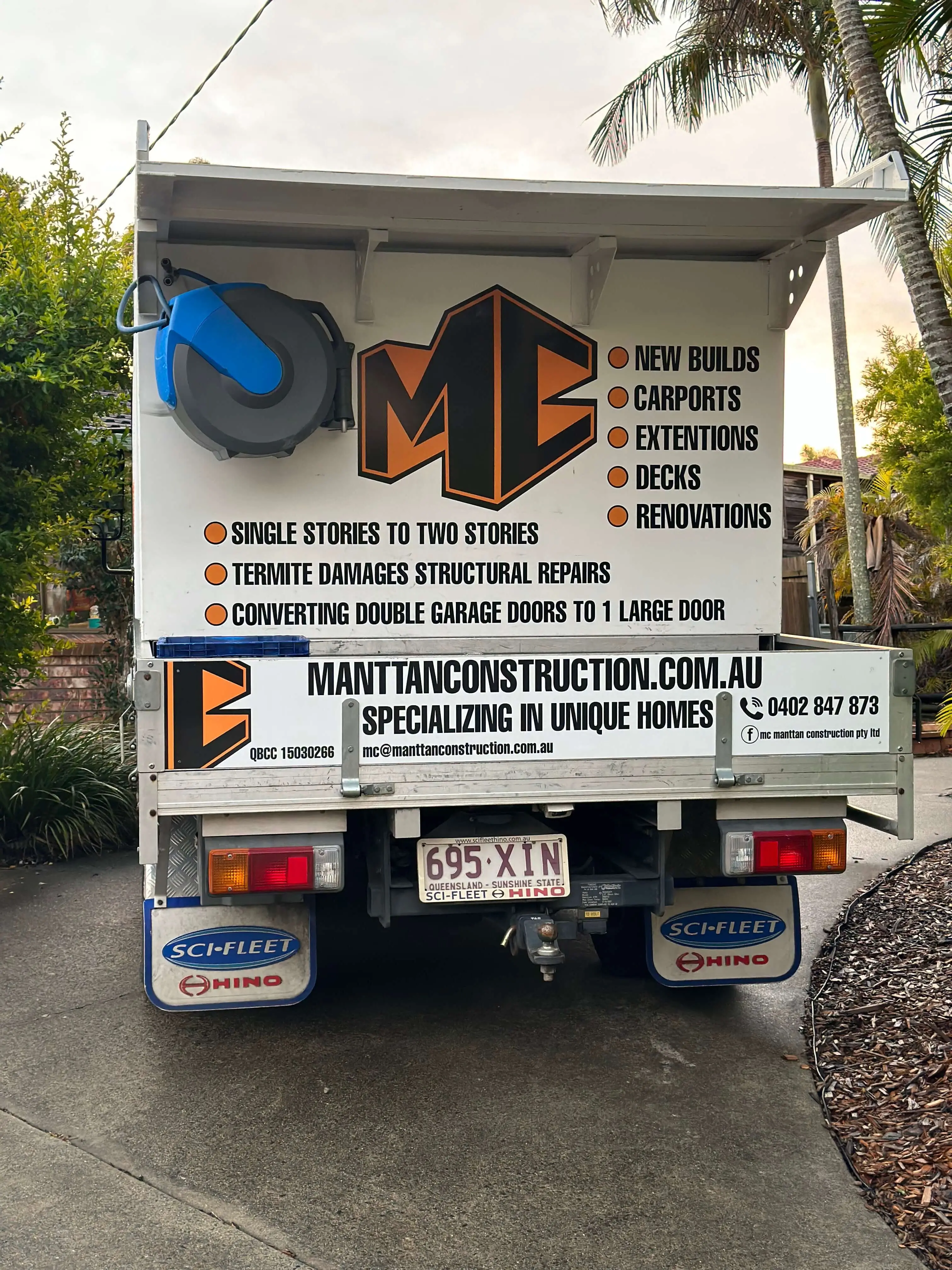 Rear of the Manttan Construction truck listing new builds, carports, extensions, decks and renovations