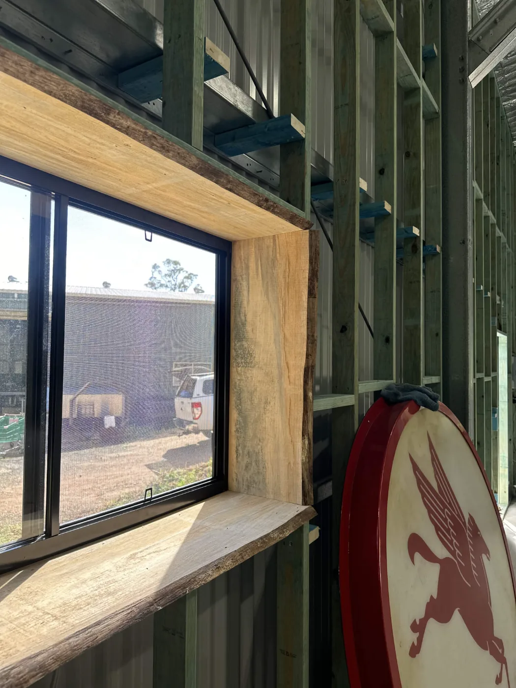 Recycled timber window surround framed into a steel shed wall, Bayside Brisbane
